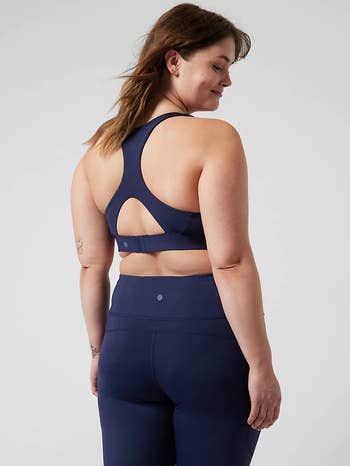 back of model wearing the navy blue ultimate sports bra with matching leggings