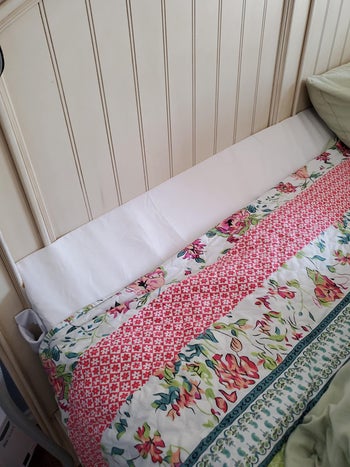 the white triangular wedge pillow on a reviewer's bed