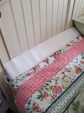 the white triangular wedge pillow on a reviewer's bed