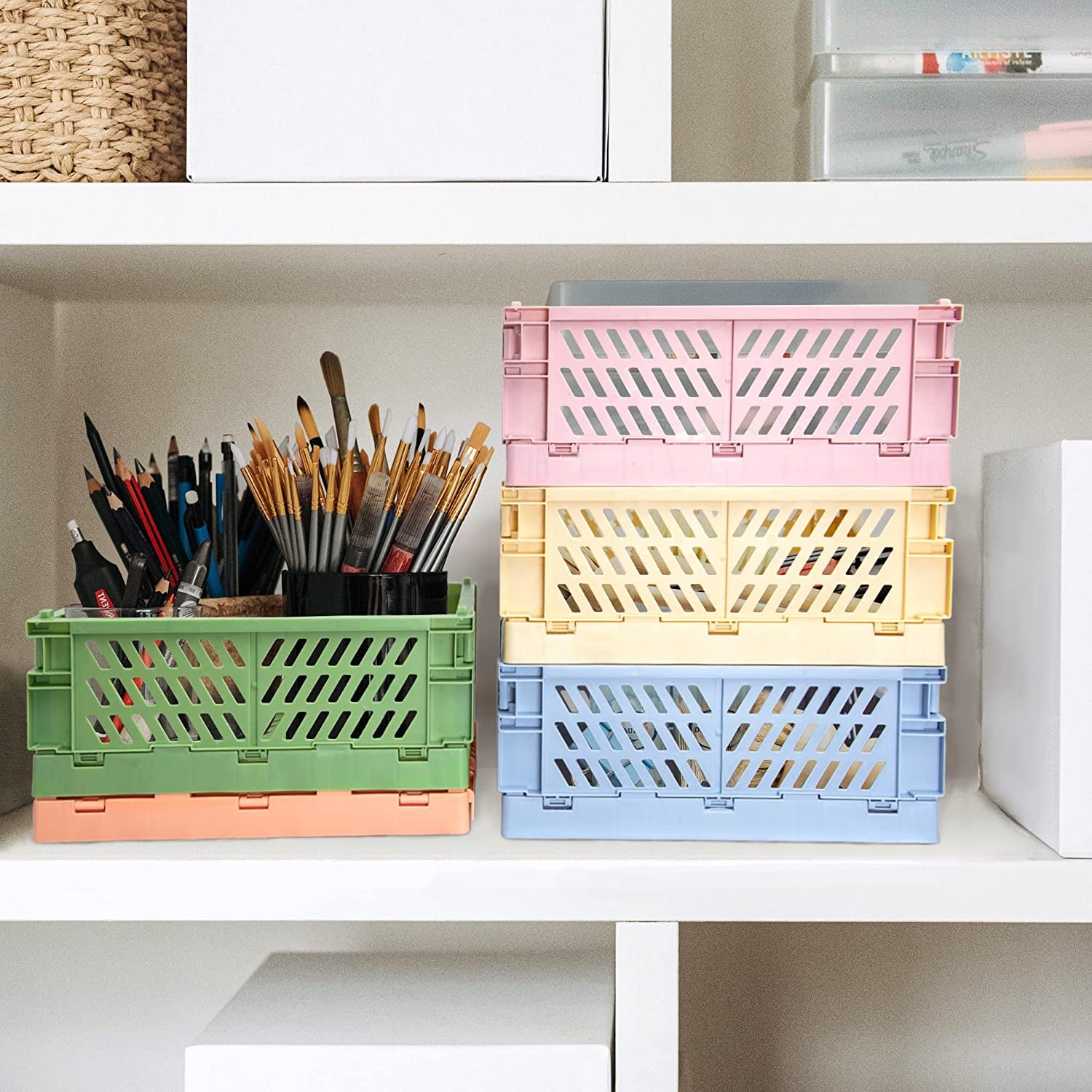 Colorful plastic collapsable baskets that hold art supplies, and is placed on a shelf