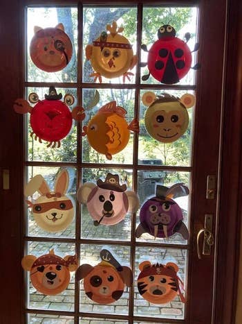 a reviewer's door covered in paper plate animals