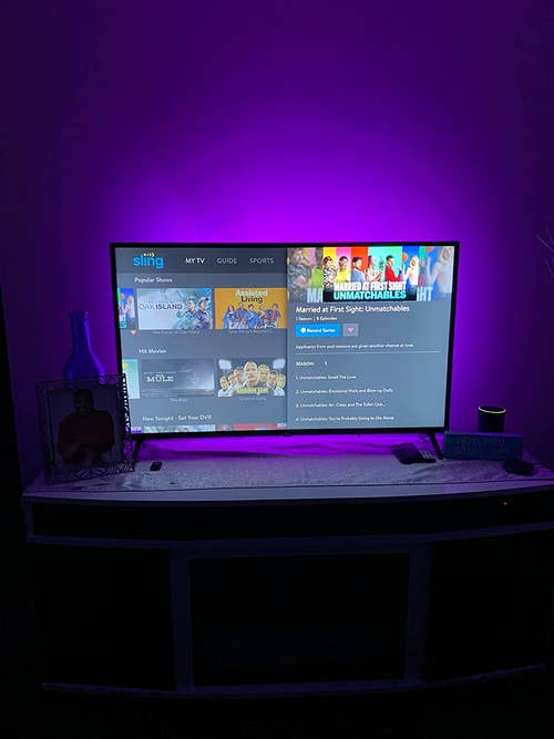 a reviewer shows the lights behind a tv in purple