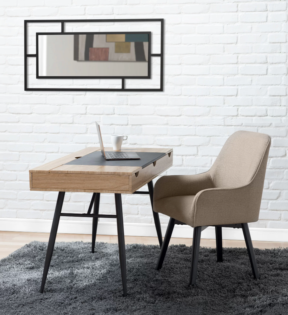 Tan upholstered chair with black legs on gray fluffy carpet in front of wooden desk