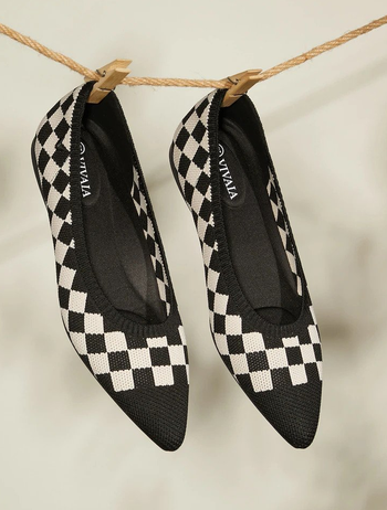 a pair of knit pointed to flats featuring a black and white checkerboard pattern 