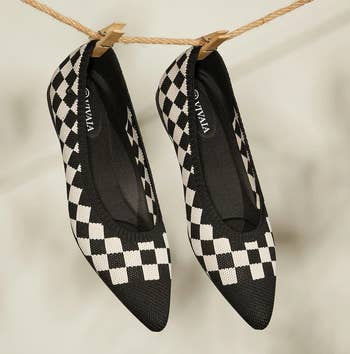 a pair of knit pointed to flats featuring a black and white checkerboard pattern 