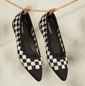 a pair of knit pointed to flats featuring a black and white checkerboard pattern 