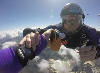 two people making the potato head while skydiving. review image.