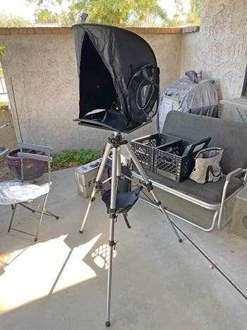 reviewer image of the laptop shade covering a laptop on a tripod outside