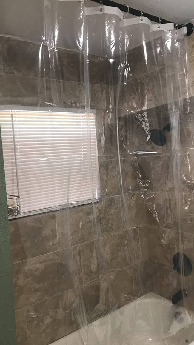 a reviewer's clear shower curtain liner