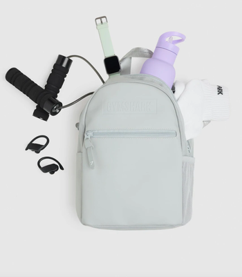 gym products inside gray mini backpack