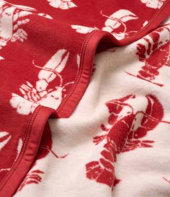 Close-up of a fleece scarf featuring a lobster pattern, showcasing brushed texture suitable for acold weather