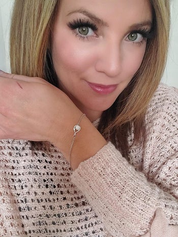 Reviewer wearing the white and silver bracelet