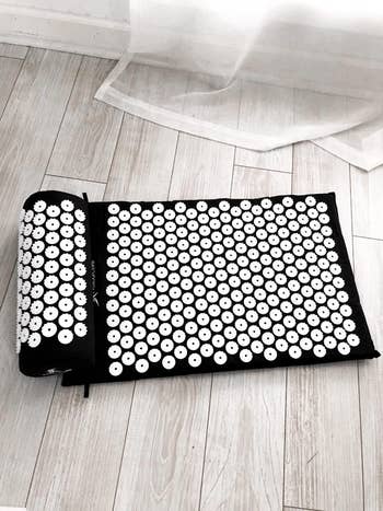 the black mat with white spikes