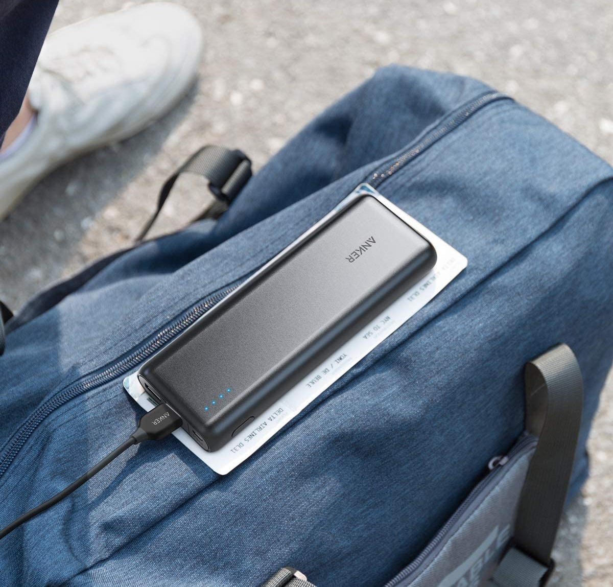 The portable charger on top of a carry-on bag