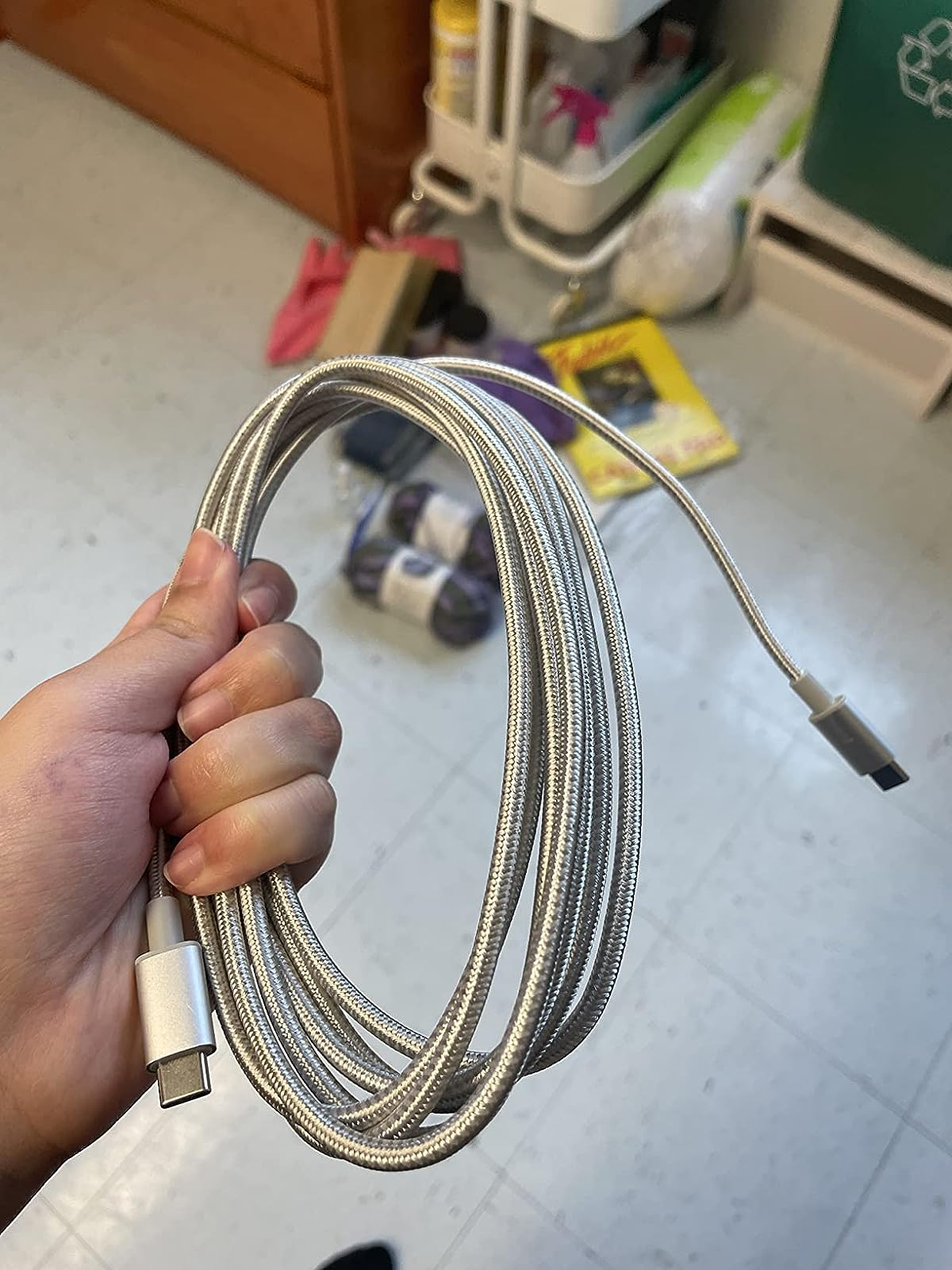 reviewer holds up the charging cable