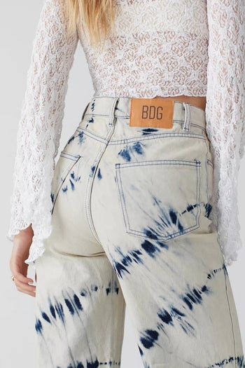 back of a model wearing the blue and white tie dye jeans