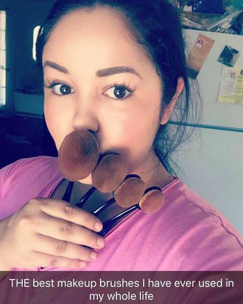 reviewer holding up 5 constitution brushes to her look with a caption stating,