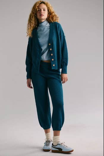 Person successful  cozy knit cardigan and pants with sneakers, stylish casual look