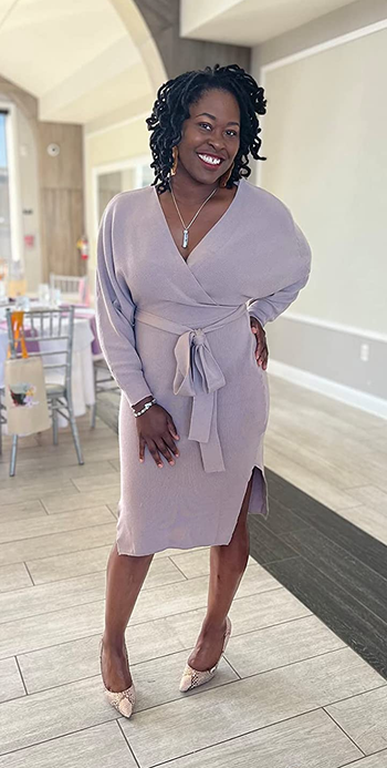 A reviewer wearing the dress in pink