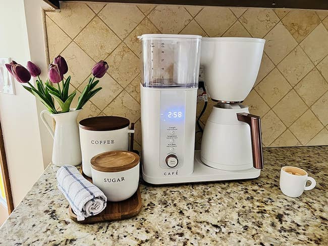 a reviewer's white drip coffee maker on a counter