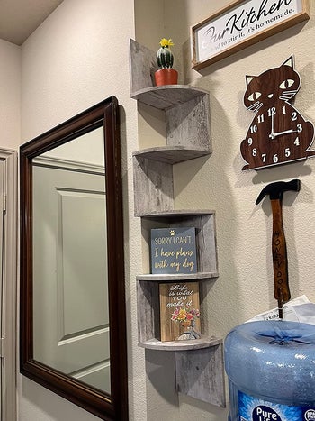 The shelf in gray with a plant and canvas art