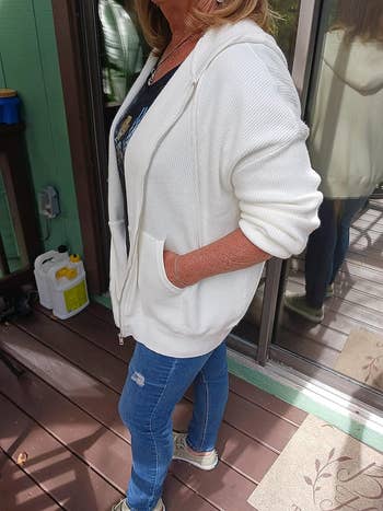 a reviewer wearing the hoodie in white