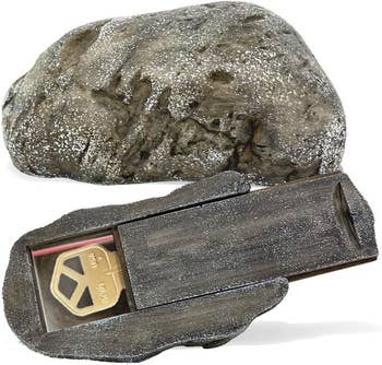 Decorative outdoor rock with a hidden compartment for securely storing a spare key, useful for home safety and convenience