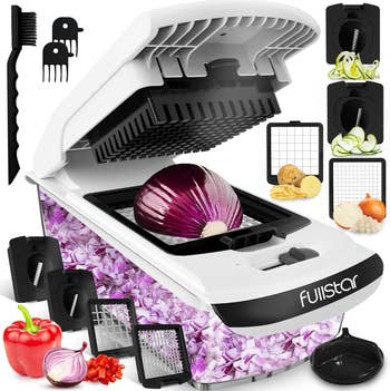 Fullstar vegetable chopper with various blades and attachments, showcasing sliced vegetables and a diced onion in the chopper