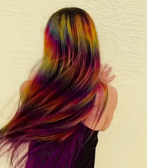 a gif of a reviewer shaking their rainbow hair