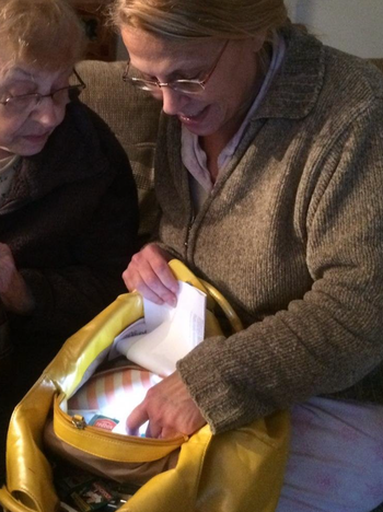 Reviewer reaching into a lit up purse