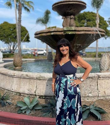 reviewer wearing navy and floral maxi dress