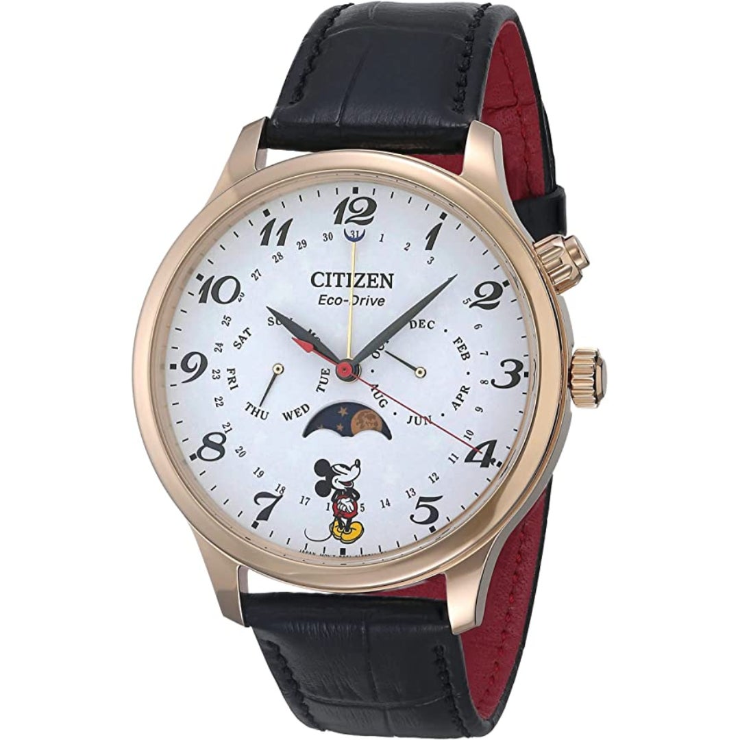 a gold round watch with a small mickey where the 6 would be and a black band
