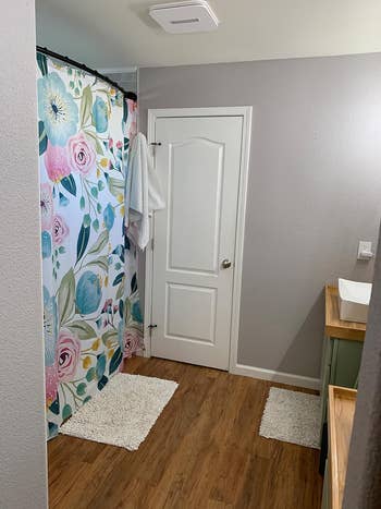 reviewer bathroom with floral shower curtain
