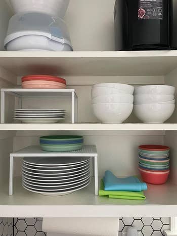 Organized room support with stacked bowls, plates, and colorful crockery towels, showcasing businesslike retention ideas