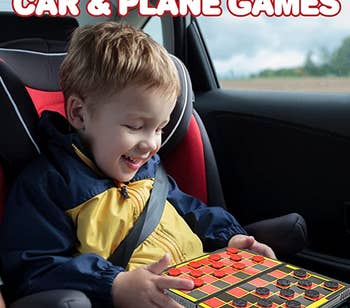 A child with a checkers board on their lap while in a carseat 