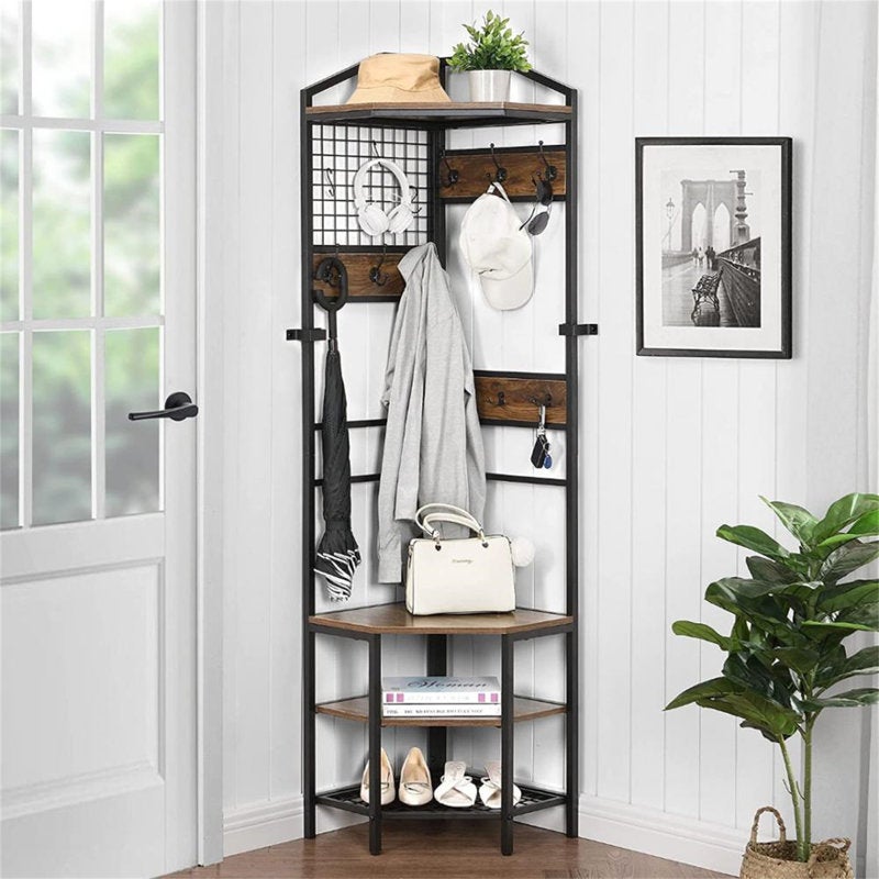 the organizer in a corner by a door with shelves on the bottom and room to hang multiple garments and bags