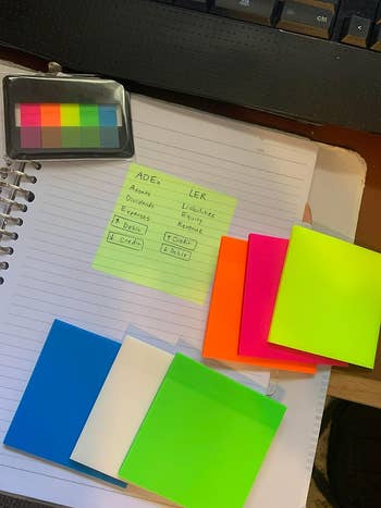 reviewers colorful transparent sticky notes, one with notes on it