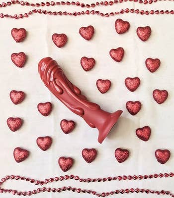 Red textured dildo surrounded by hearts