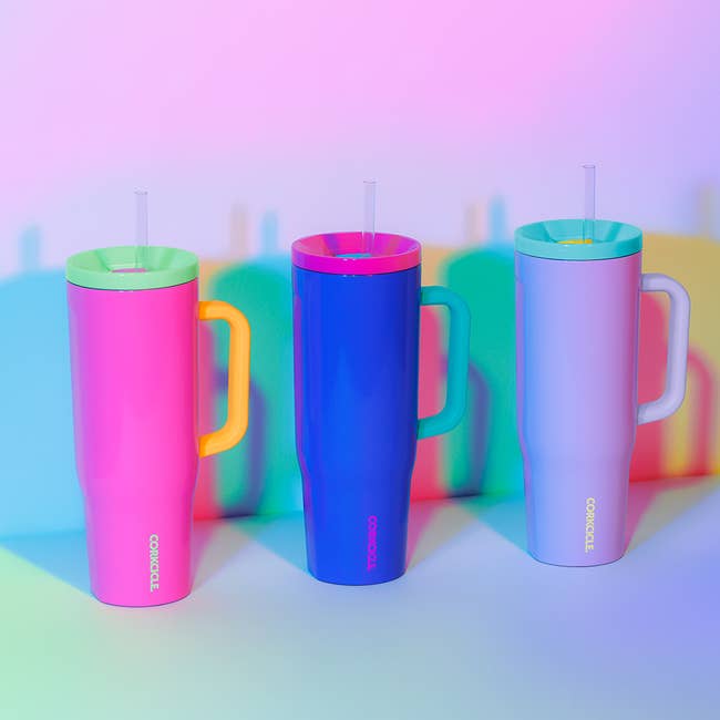 an array of vibrantly colored corkcicle tumblers with handles