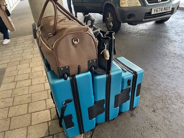 a reviewer photo of the three-piece luggage set connected together 