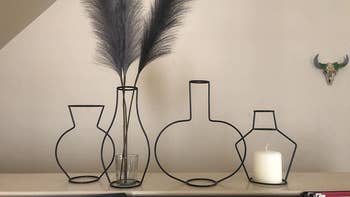 different shaped vases being used for a feather pampas piece and candle holder