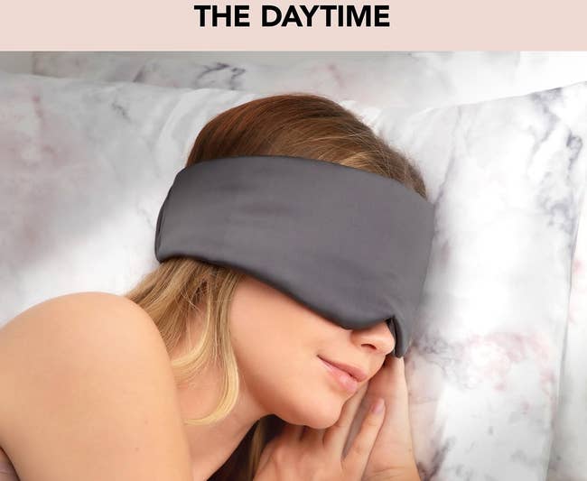 A model in the grey eye mask which wraps around instead of having an elastic band
