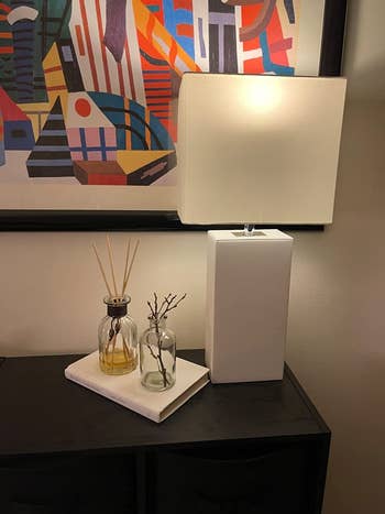 reviewer image of the white leather lamp on a nightstand