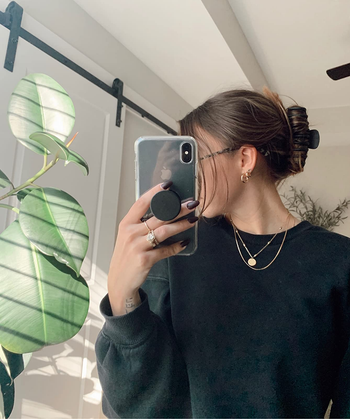 reviewer wearing the black hair claw to keep their hair up and away from their neck
