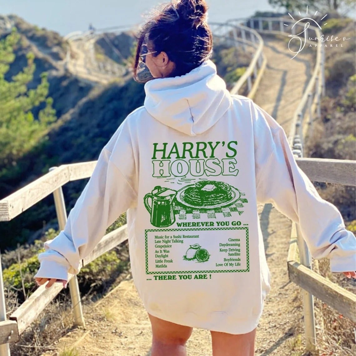 model wearing the white sweatshirt and showing the back with a 'harry's House