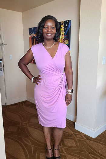 reviewer wearing the dress in lavender that hits below the knee