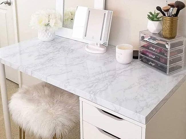 Faux white granite covering a white desk