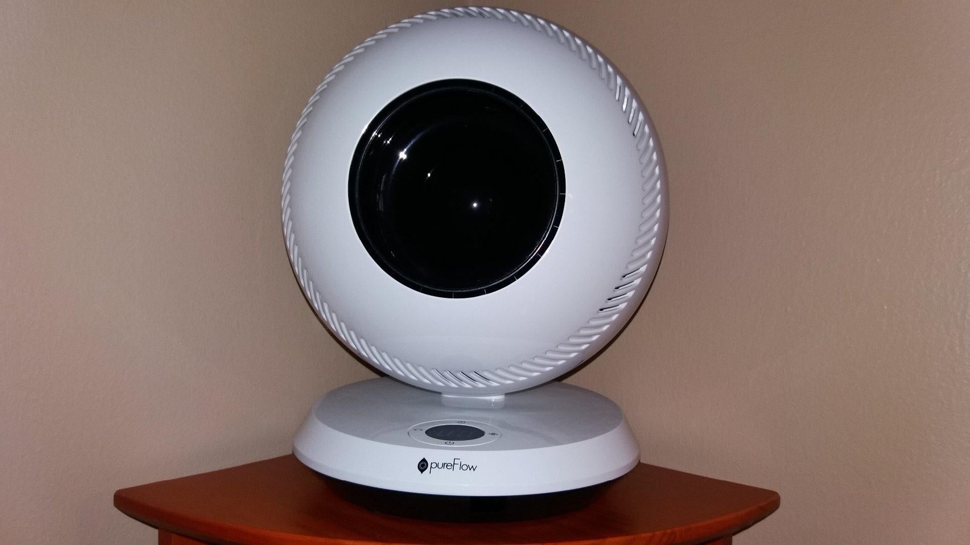 A reviewer's dual fan/heater on a small table