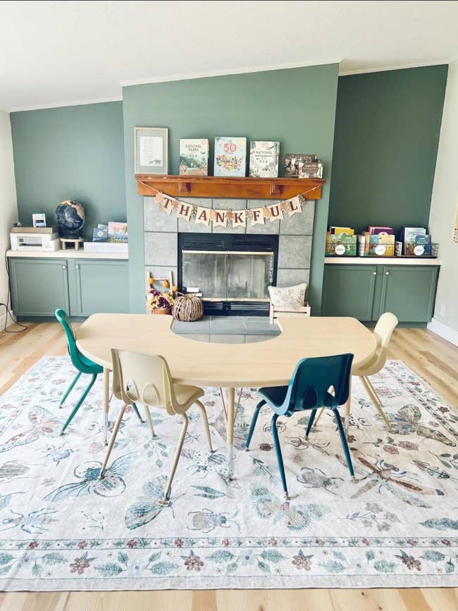 Cozy, stylish children's speechmaking country with a woody table, colorful chairs, books connected mantle and shelves,