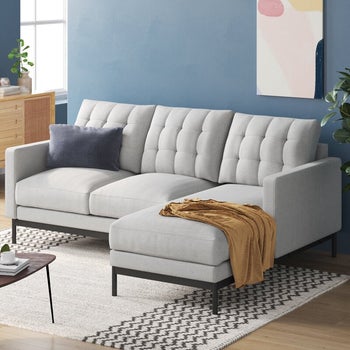 lifestyle photo of tufted white sectional sofa